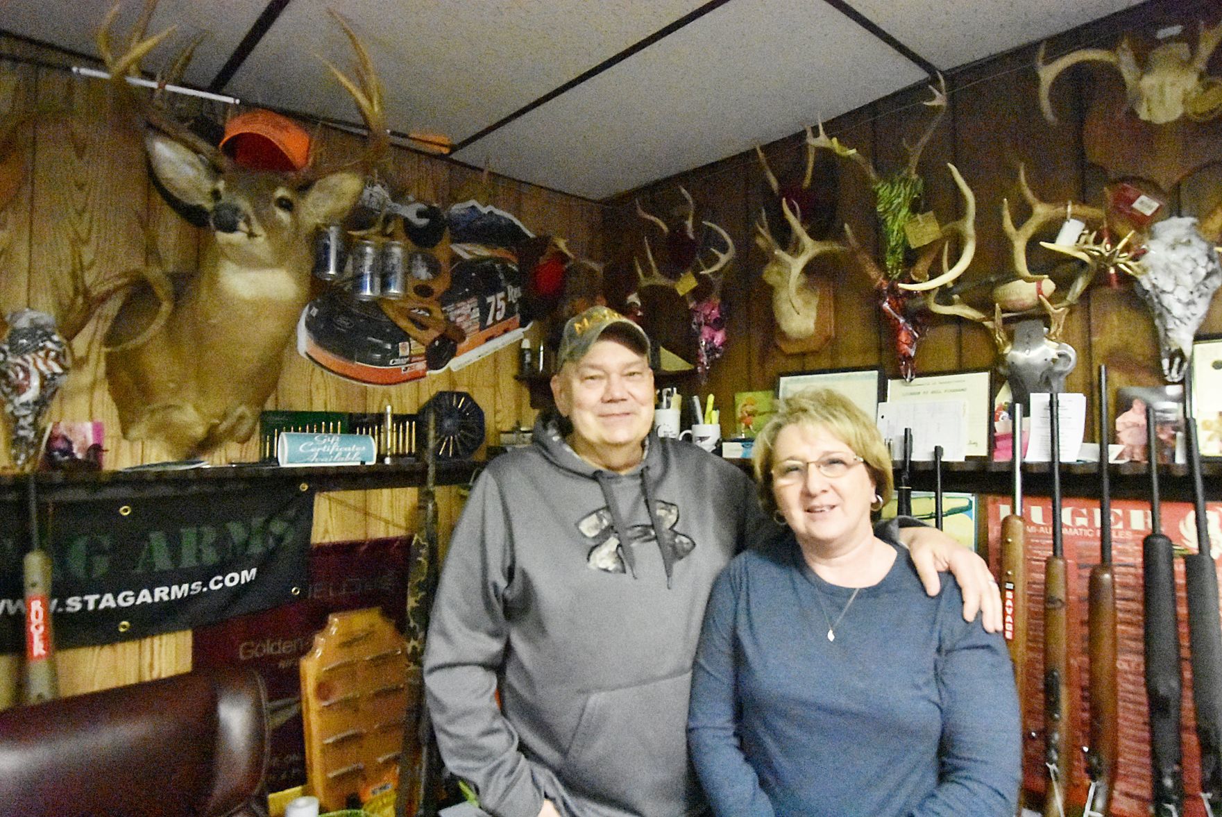 Bob and Linda Kahler stand inside their local gun shop
